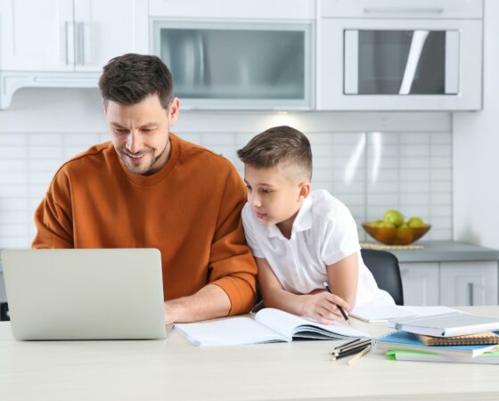 man-young-boy-use-laptop-in-kitchen