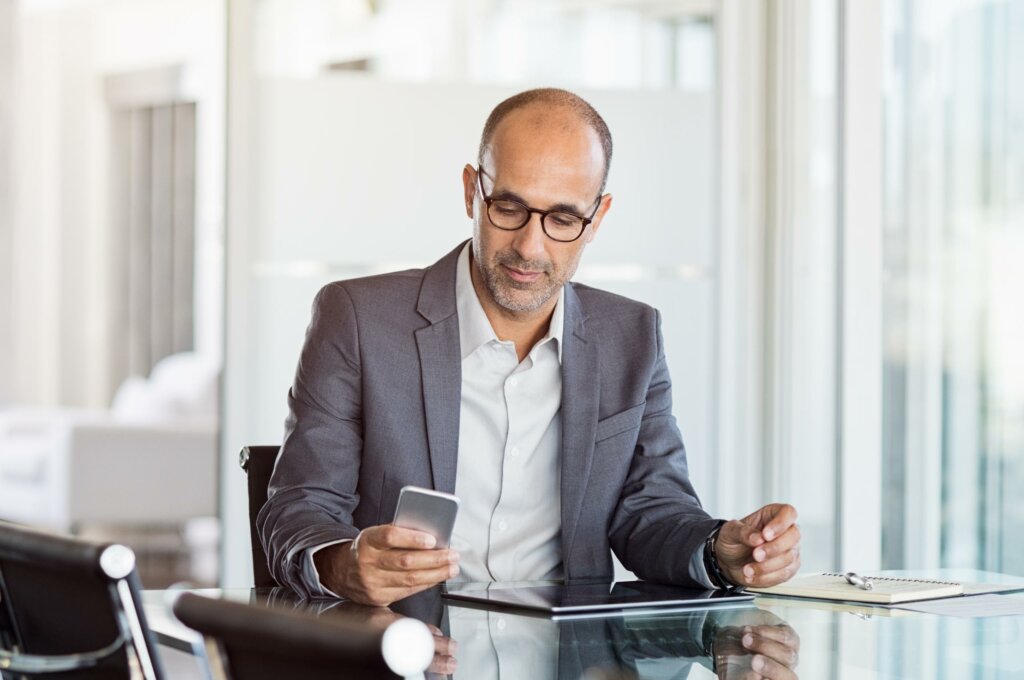 Mature-business-man-working-on-mobile