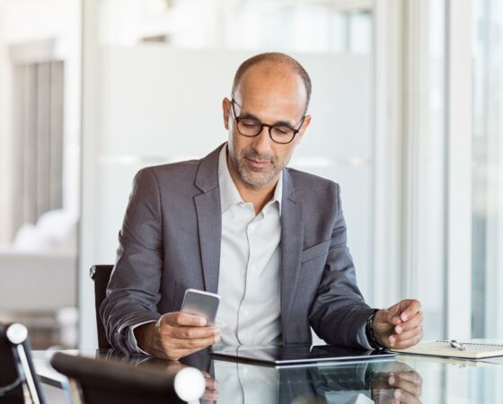 Mature-business-man-working-on-mobile