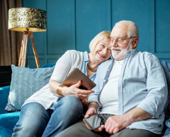 mature-man-woman-holding-tablet