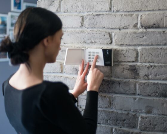 Young woman setting alarm security