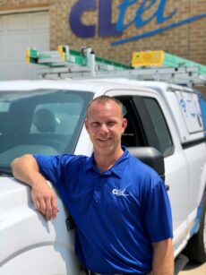 IT technician standing next to pickup