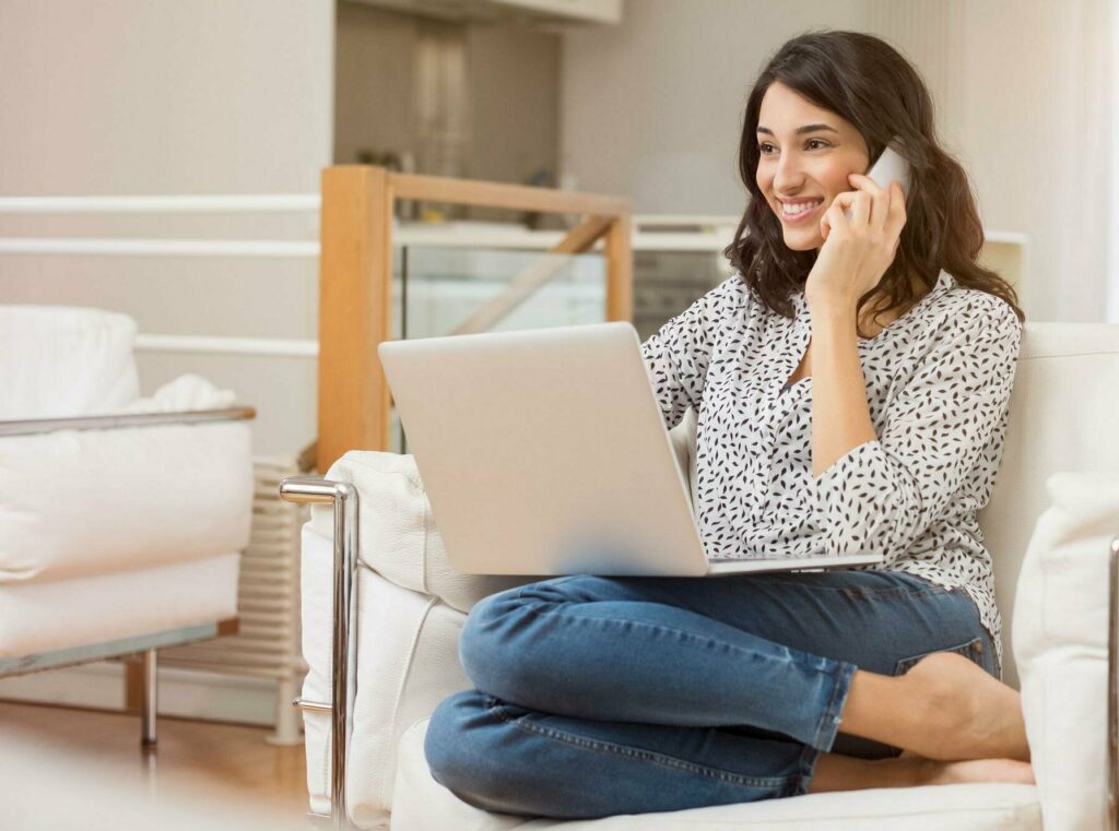 Woman talks on phone in home