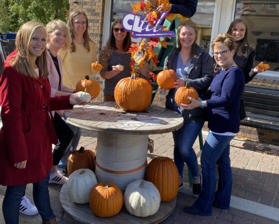 CL Tel employees with pumpkins outdoors