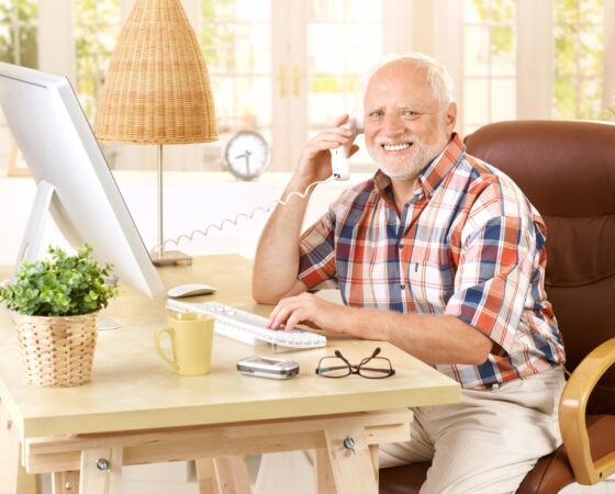 Happy mature man on landline call