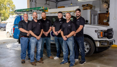 CL Tel technicians standing in garage.