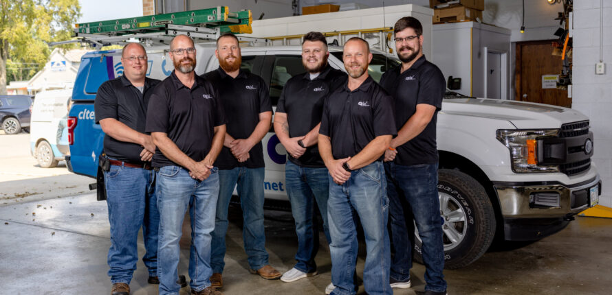 CLtel technicians standing in garage.